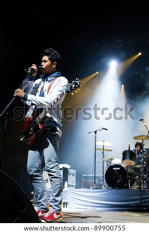 SEATTLE - DECEMBER 8, 2010:  Lead Singer Dougy Mandagi of Australian indie rock band the Temper Trap performs on stage during the Deck the Hall Ball in Seattle on December 8, 2010.