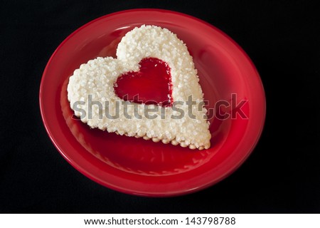 Heart shaped sugar cookie with a strawberry jam heart shaped center
