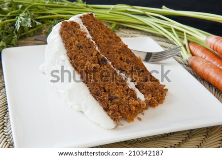 Piece of carrot cake with fresh carrots