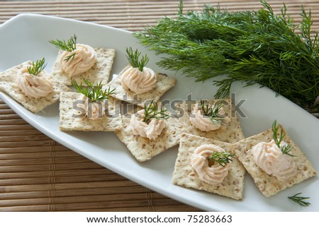 Salmon pate on multigrain crackers with dill