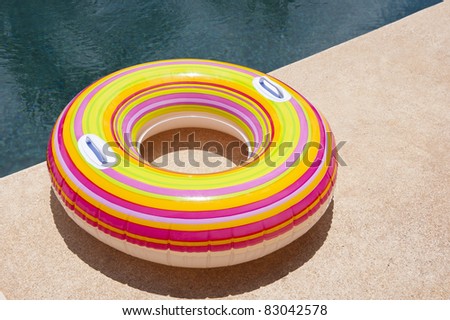 Colorful pool tube sitting on the pool deck