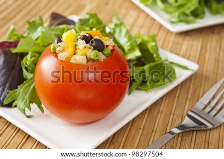 Tomato stuffed with quinoa and vegetables with field greens salad