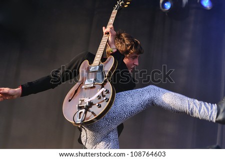 BENICASSIM, SPAIN - JULY 13: Miles Kane jumps with a kick at FIB on July 13, 2012 in Benicassim, Spain. Festival Internacional de Benicassim.