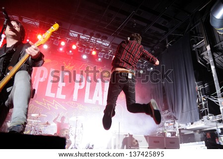 BARCELONA, SPAIN - MARCH 13: Pierre Bouvier, lead singer of Simple Plan, French-Canadian rock band from Montréal, Québec, jumps on his concert at Razzmatazz on March 13, 2012 in Barcelona, Spain.