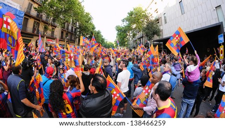 BARCELONA - MAY 13: Thousands of people joins Bars players on the streets of the Catalan capital to celebrate the club winning its 22nd league title on May 13, 2013 in Barcelona, Spain.