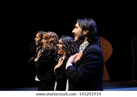 BARCELONA - JAN 13: Actors dressed in business suit, of the Barcelona Theater Institute, sing and dance in the comedy Shakespeare For Executives on January 13, 2013 in Barcelona, Spain.