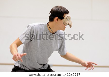 BARCELONA - MAR 3: An actor with a mask plays Commedia dell'arte on March 3, 2011 in Barcelona, Spain. Is a form of theater characterized by masked types which began in Italy.