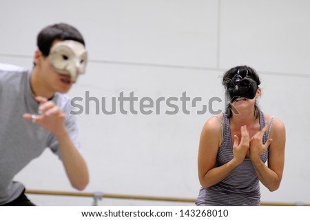 BARCELONA - MAR 3: An actor and an actress with masks play Commedia dell\'arte on March 3, 2011 in Barcelona, Spain. Is a form of theater characterized by masked types which began in Italy.