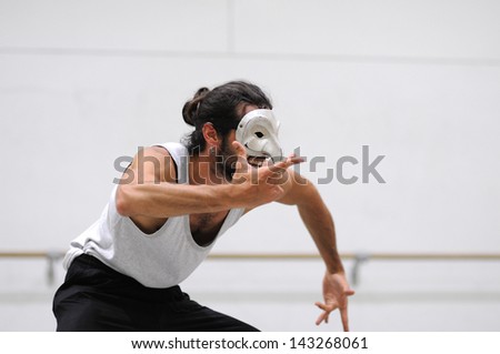 BARCELONA - MAR 3: An actor with a mask plays Commedia dell\'arte on March 3, 2011 in Barcelona, Spain. Is a form of theater characterized by masked types which began in Italy.