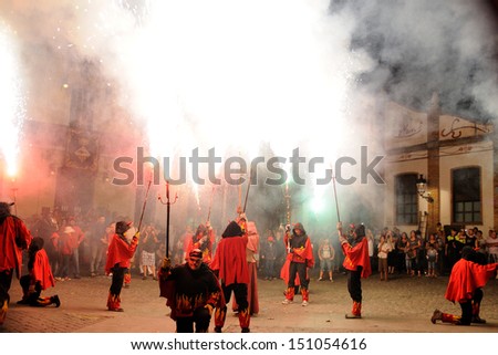 BARCELONA - AUG 17: Fire devils in the Fire-Run (Correfoc) as part of the Mollet estival party (festa major) on August 17, 2013 in Mollet del Valles, Barcelona, Spain.