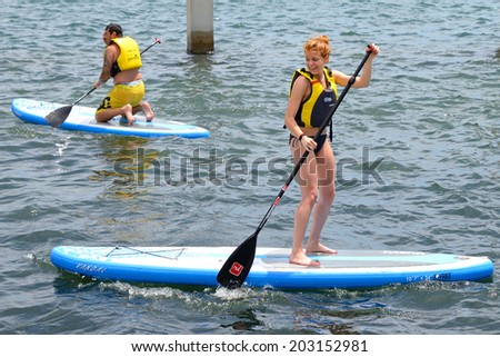 BARCELONA - JUN 28: People doing Stand up paddle surfing, or boarding (SUP), at LKXA Extreme Sports Barcelona Games on June 28, 2014 in Barcelona, Spain.