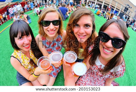 BARCELONA - JUN 12: Girls holding beer glasses at Sonar Festival on June 12, 2014 in Barcelona, Spain.