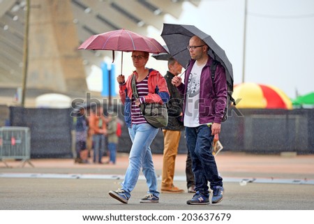 BARCELONA - MAY 28: People with umbrellas, under the rain at Heineken Primavera Sound 2014 Festival (PS14) on May 28, 2014 in Barcelona, Spain.