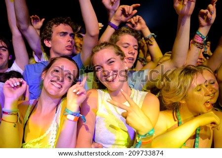 BENICASSIM, SPAIN - JULY 19: Women watching a concert in the crowd at FIB Festival on July 19, 2014 in Benicassim, Spain.