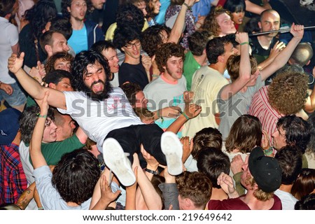 BARCELONA - MAY 30: The audience doing crowd surfing (also known as mosh pit) at Heineken Primavera Sound 2014 Festival on May 30, 2014 in Barcelona, Spain.