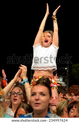 BENICASSIM, SPAIN - JULY 20: Woman from the audience applauding in a concert at FIB Festival on July 20, 2014 in Benicassim, Spain.