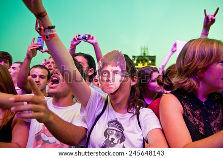 BENICASSIM, SPAIN - JULY 19: A woman from the crowd with a mask of Noel Gallagher (Oasis) at FIB (Festival Internacional de Benicassim) 2013 Festival on July 19, 2013 in Benicassim, Spain.
