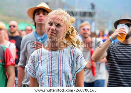 BENICASSIM, SPAIN - JULY 18: A blonde woman dances in a concert at FIB Festival on July 18, 2014 in Benicassim, Spain.