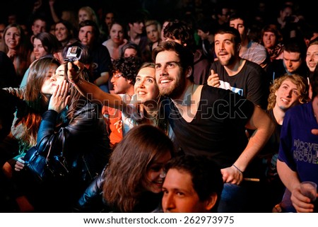 BARCELONA - MAR 18: A couple from the crowd takes a selfie with a Gopro camera at Bikini stage on March 18, 2015 in Barcelona, Spain.