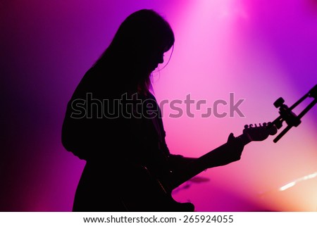 BARCELONA - APR 9: Silhouette of the female guitar player of Blood Red Shoes (band) performs at Discotheque Razzmatazz on April 9, 2010 in Barcelona, Spain.
