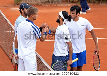 BARCELONA - APR 20: The players of the team Klizan (left) and the team Shamasdin (right) greet after the match at the ATP Barcelona Conde de Godo tournament on April 20, 2015 in Barcelona, Spain.