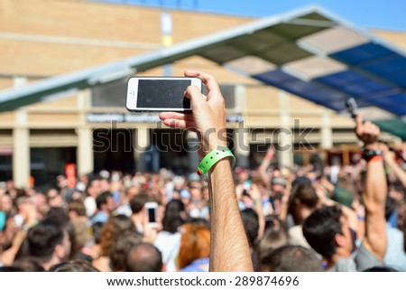 BARCELONA - JUN 18: A man with his smartphone takes a picture  in a concert at Sonar Festival on June 18, 2015 in Barcelona, Spain.