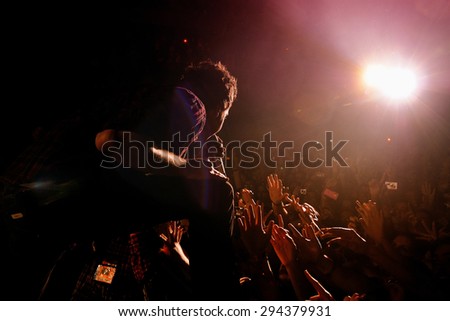 BARCELONA - MAR 13: The singer of Simple Plan (band) performs with the crowd at Razzmatazz club on March 13, 2012 in Barcelona, Spain.
