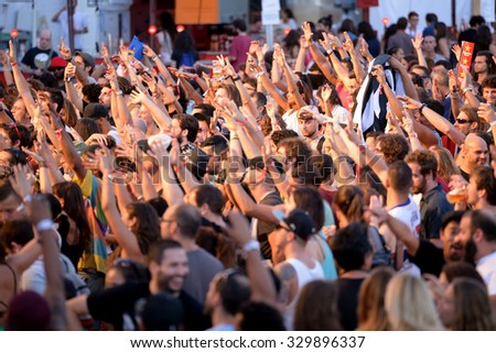 BARCELONA - JUL 10: People from the crowd with their arms raised in a concert at Cruilla Festival on July 10, 2015 in Barcelona, Spain.