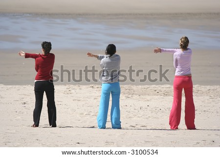 three girls in the beach relaxing (arms left)