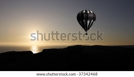 balloon flying into sunset over water