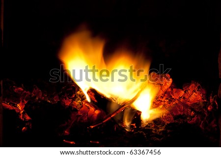 incandescent embers and flame on the black background