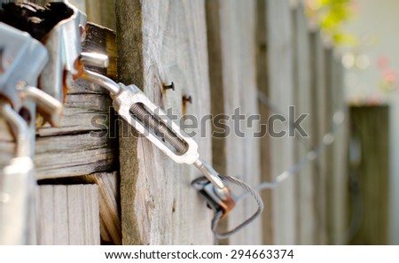 An old broken fence gate cable
