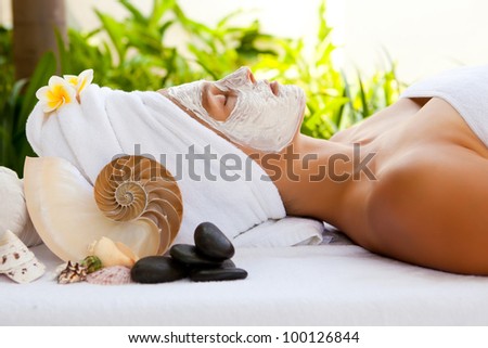 Young beautiful woman in tropical spa