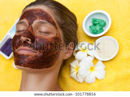 Young beautiful woman in spa making face treatment