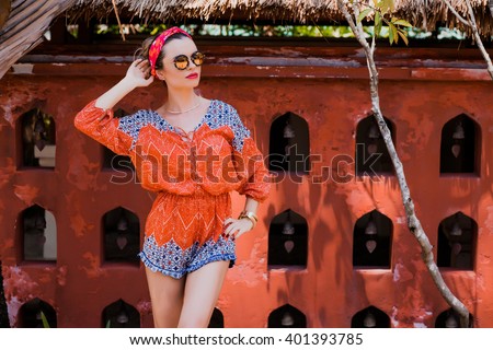 Attractive young woman among the Asian wall. Vacation. Tropics. Fashion shot.