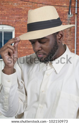 An attractive handsome African American black man in a fedora hat
