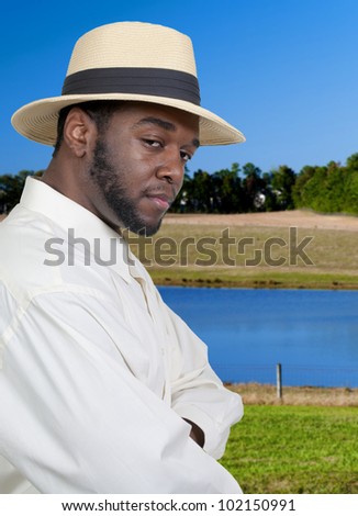 An attractive handsome African American black man in a fedora hat