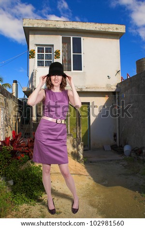 Beautiful young woman in a sleeveless mod dress and cloche bell hat
