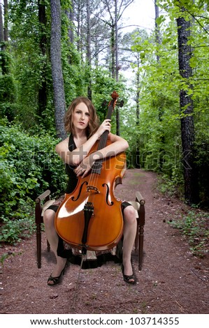 Beautiful woman cellist with her cello musical instrument