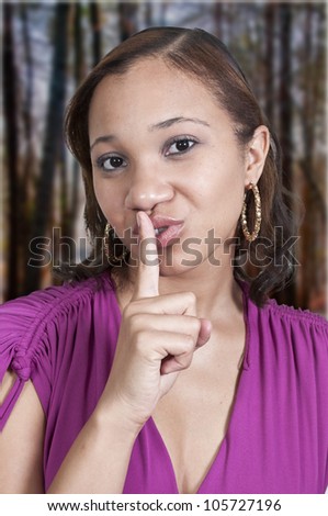 Black African American woman saying be quiet by saying shhh