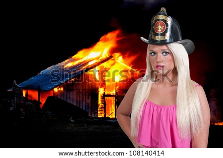Beautiful young woman firefighter at a fire