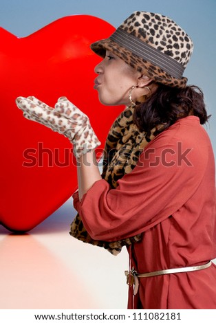Beautiful young black African American woman blowing a kiss