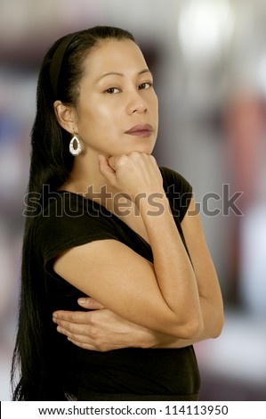 A beautiful young hispanic latino woman looking far away