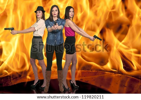 Beautiful police detective women on the job with guns in a fire