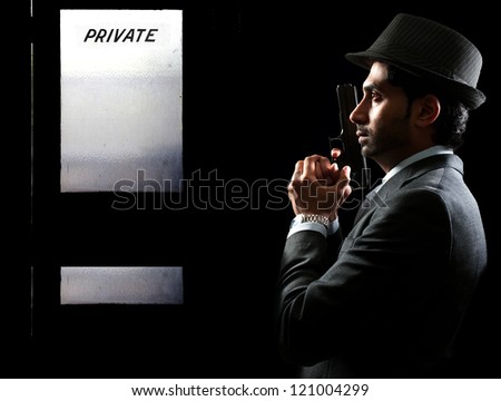 Male police private detective man on the job with a gun