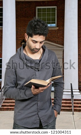 A handsome Arab man reading a book
