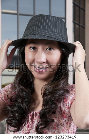 Beautiful asian woman in a fedora hat