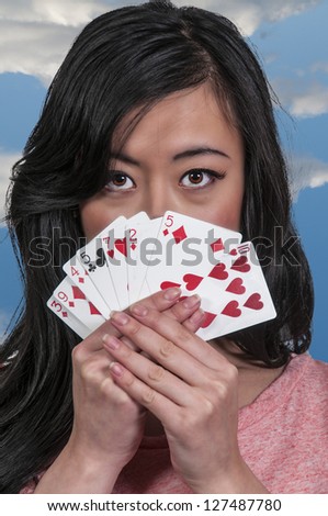 Beautiful woman playing with a deck of cards -- lady luck
