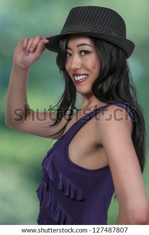 Beautiful asian woman in a fedora hat