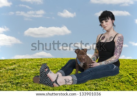 Beautiful young woman with her pit bull puppy
